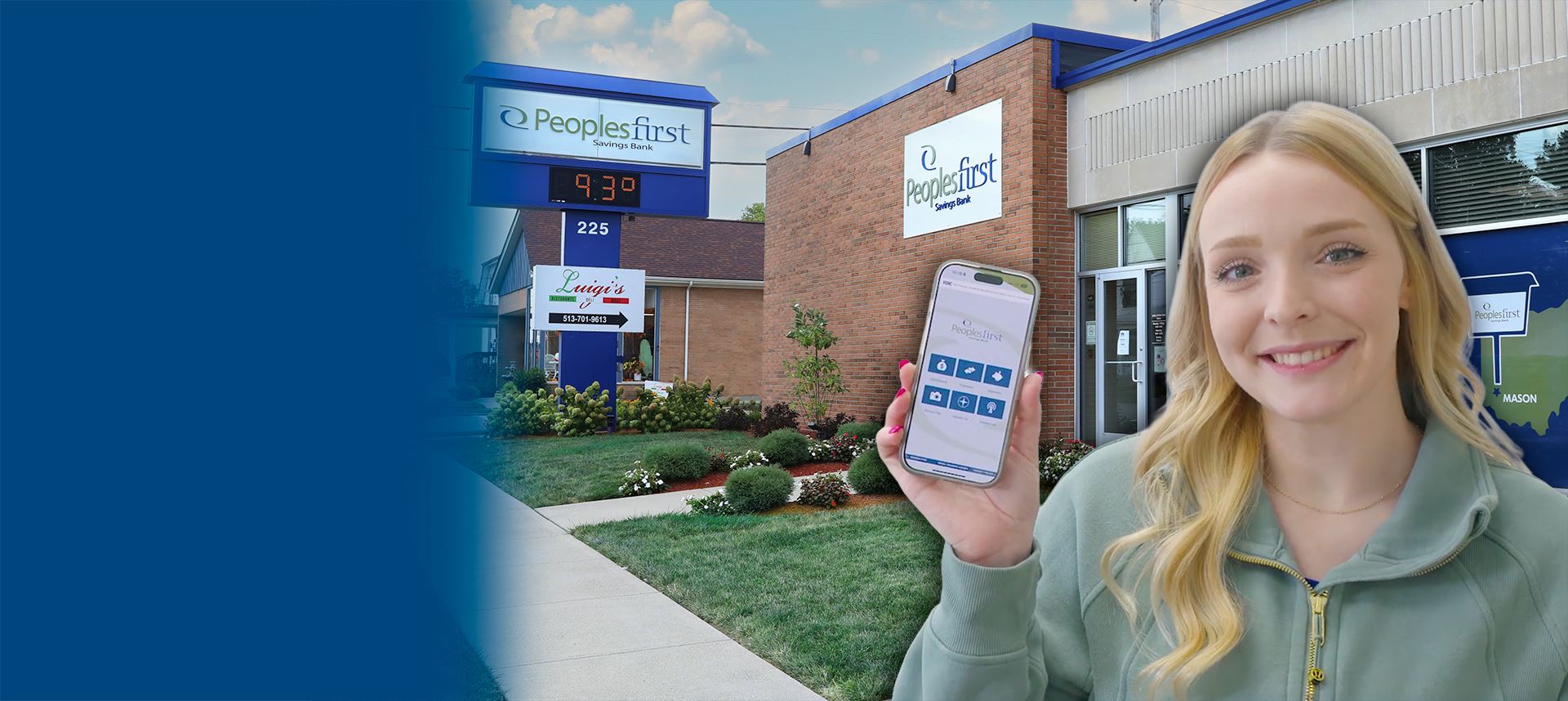 Woman holding cell phone in front of bank building