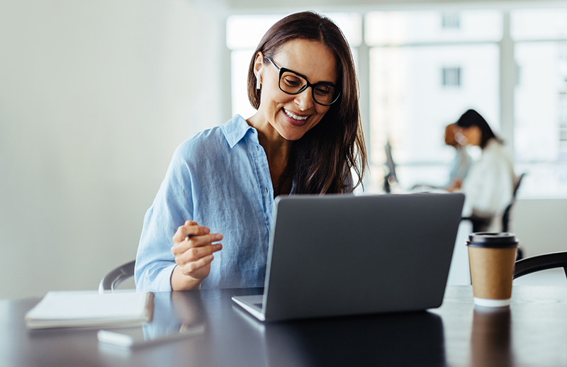 woman smiling at computer