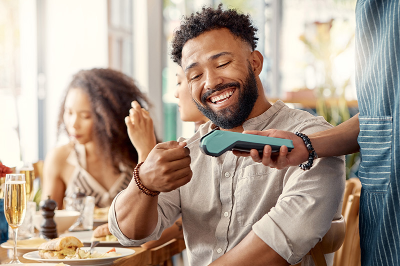 man paying with credit card